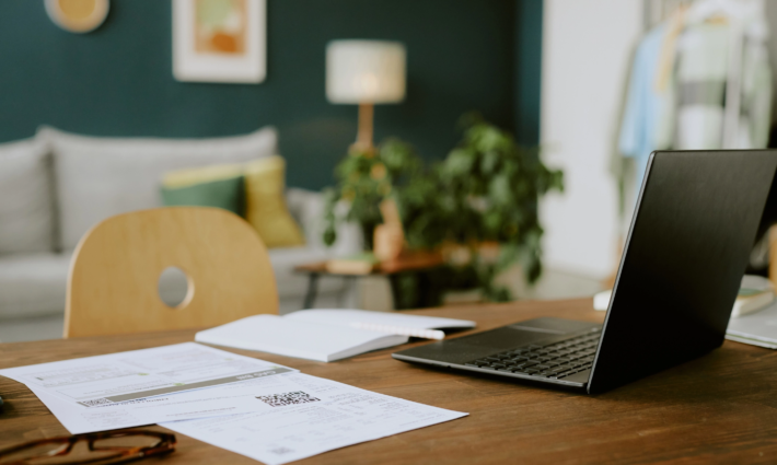 Laptop and paperwork on a desk, used when dealing with probate and estate administration.